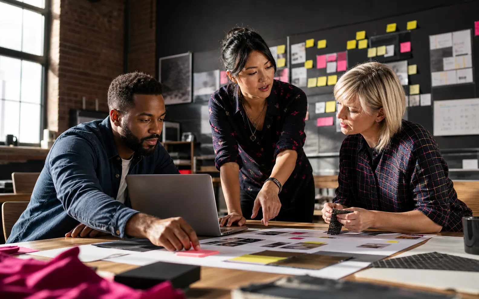 A small-business team maps and improves a practical workflow together around a shared worktable.